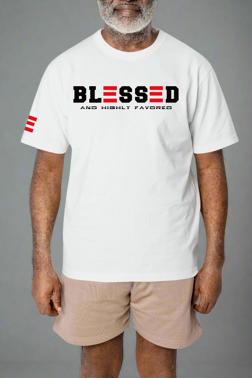 Man wearing a white t-shirt with 'BLESSED AND HIGHLY FAVORED' text and a red flag on a gray background