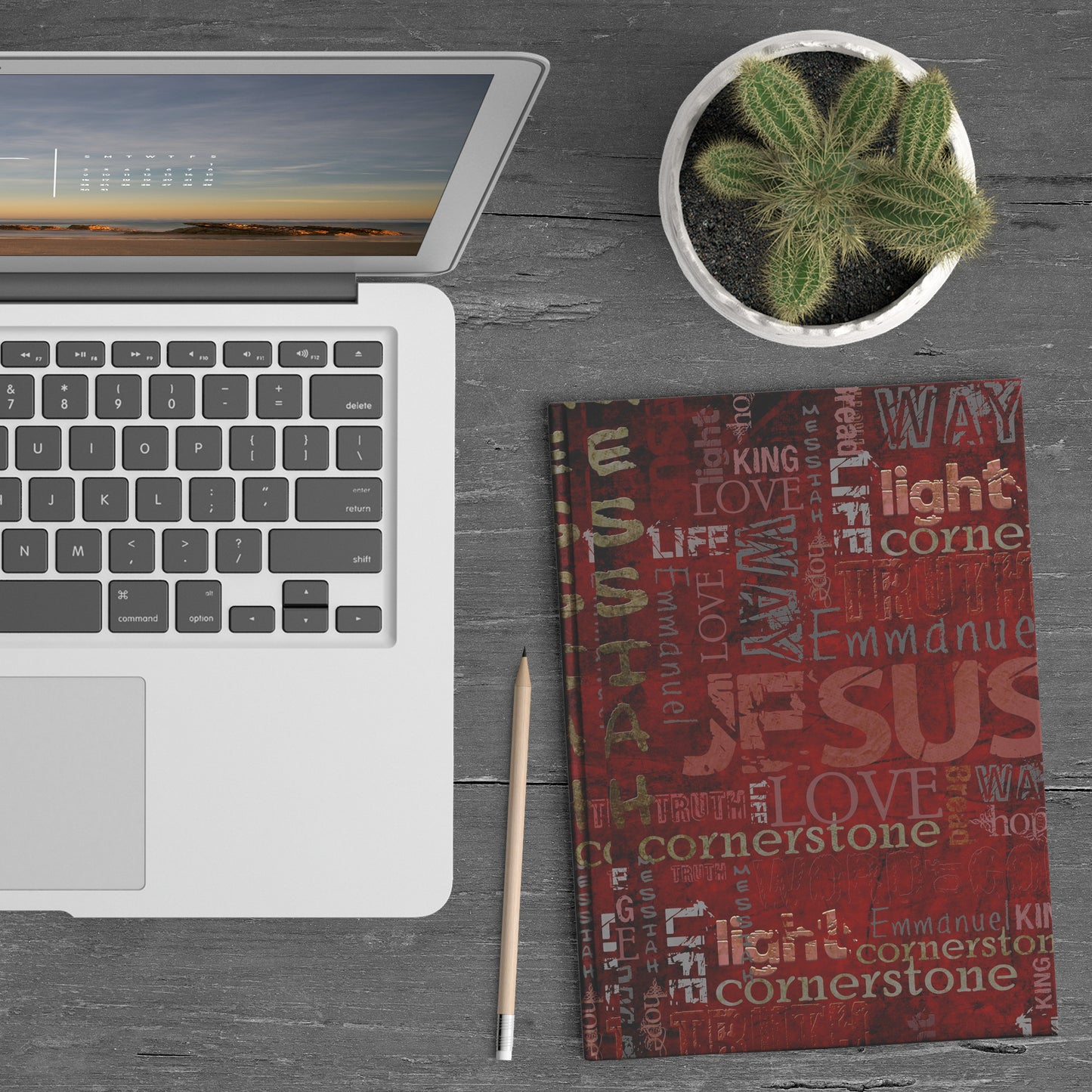 hardcover front book next to a laptop