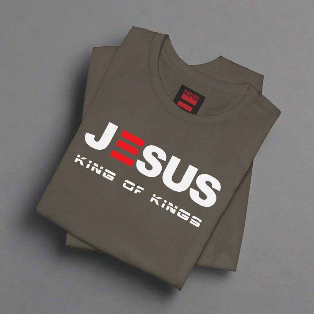Folded army green t-shirt with 'Jesus King of Kings' text on a white background