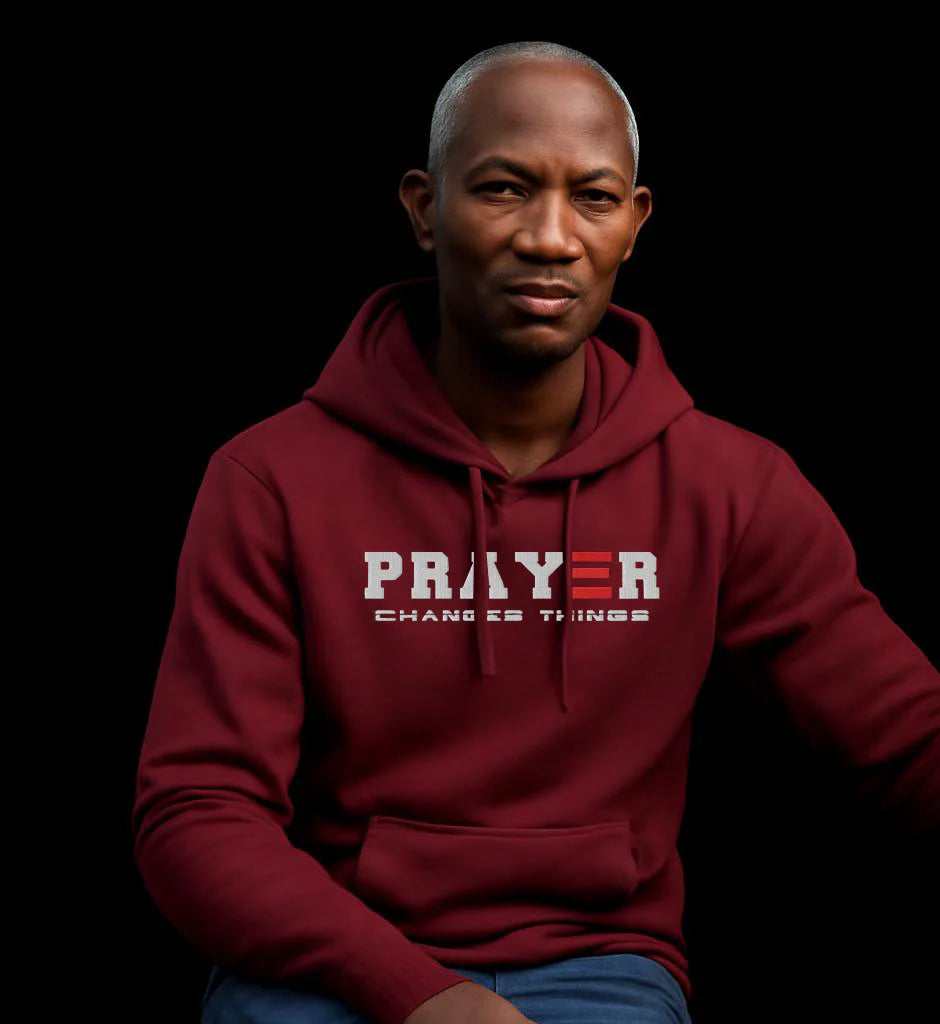 Man wearing a maroon hoodie with 'PRAYER CHANGES THINGS'