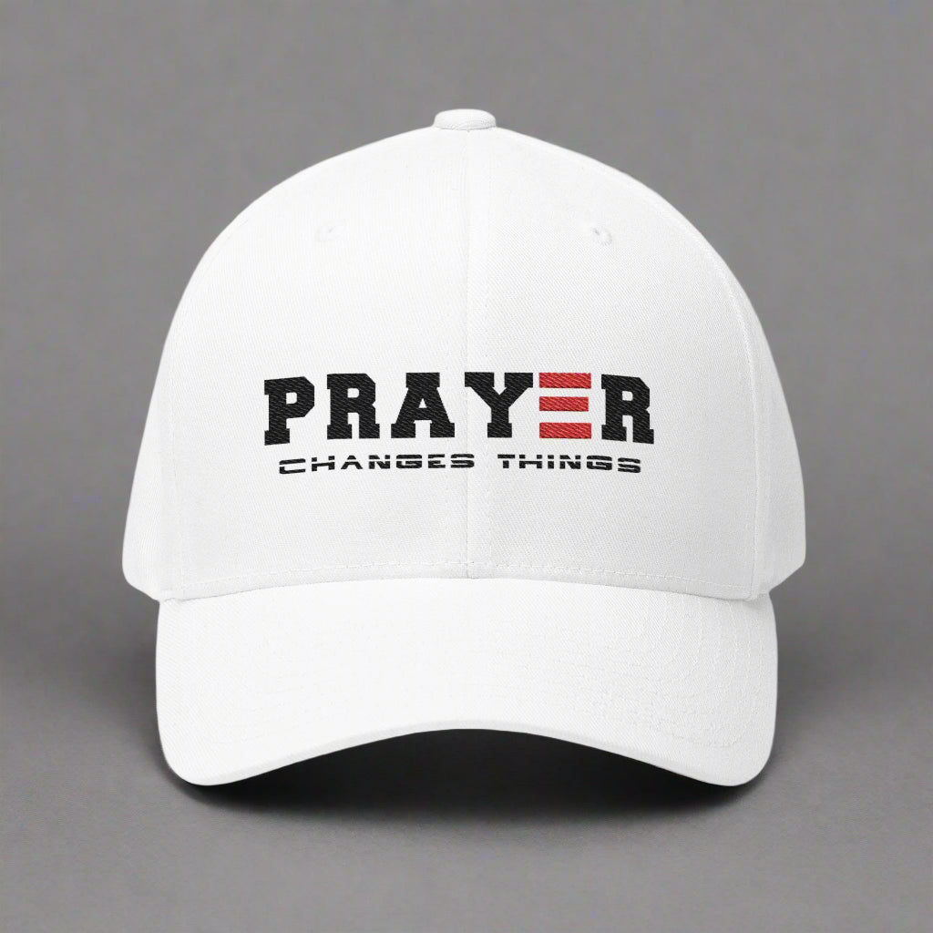 White cap with 'PRAYER CHANGES THINGS' text on a gray background