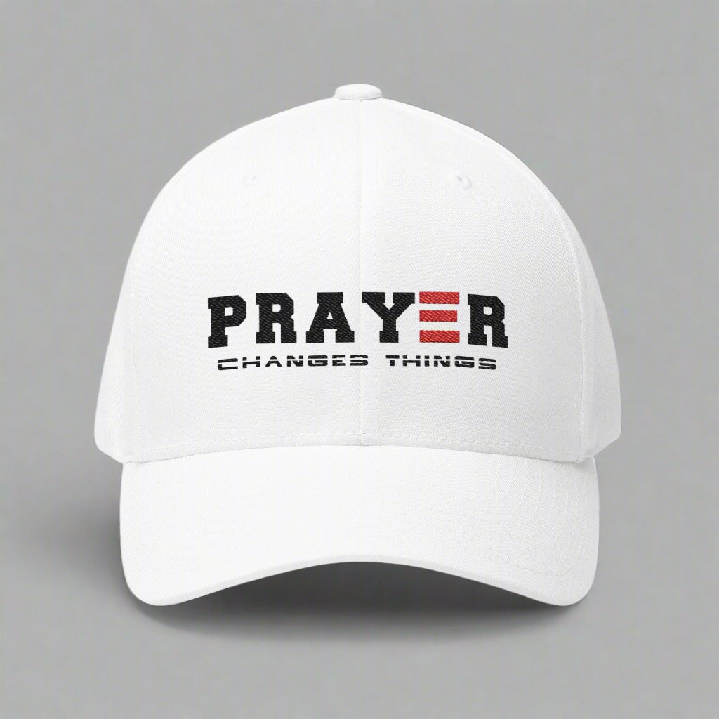 White cap with 'PRAYER CHANGES THINGS' text on a grey background
