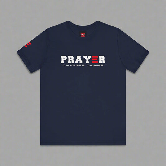 Navy blue t-shirt with 'PRAYER CHANGES THINGS' text on a gray background