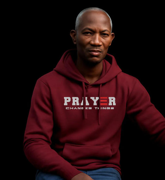 Man wearing a maroon hoodie with 'PRAYER CHANGES THINGS' 