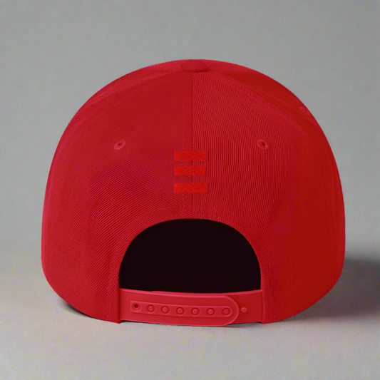 Red cap with a logo on the back against a gray  background